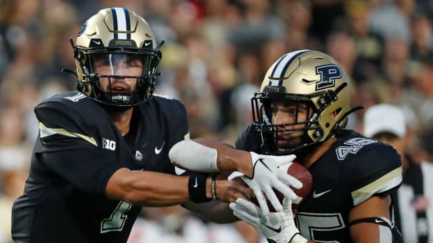 Purdue Boilermakers quarterback Hudson Card (1) hands the ball off to Purdue Boilermakers running back Devin Mockobee (45) during the NCAA football game against the Syracuse Orange